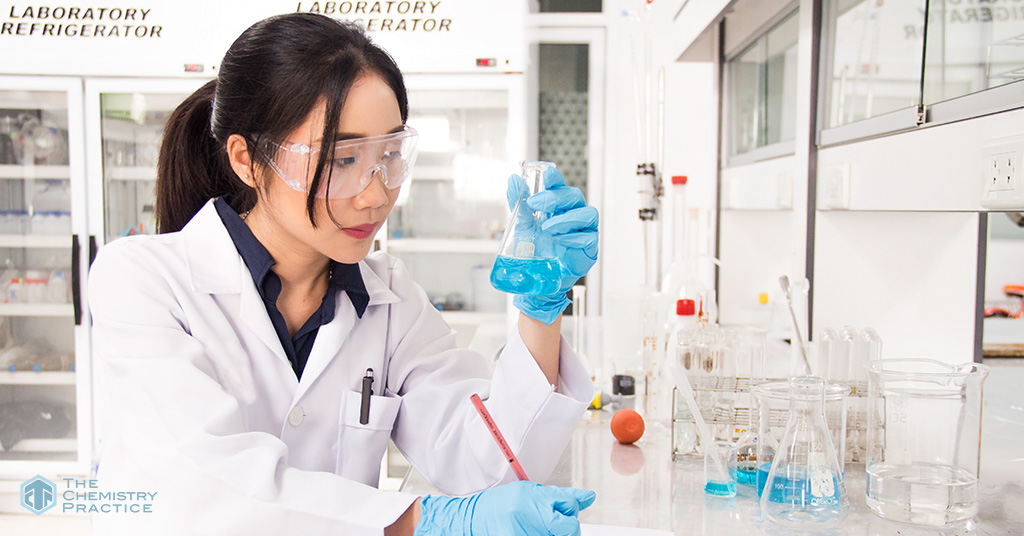 student studying for chemistry exams with equipment and apparatus on the table