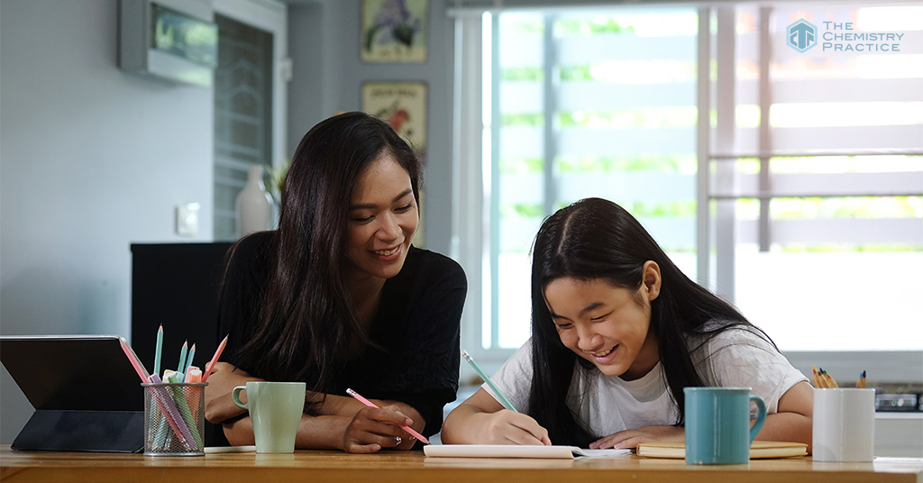 Chemistry tutor helping student reduce exam stress with focused study.